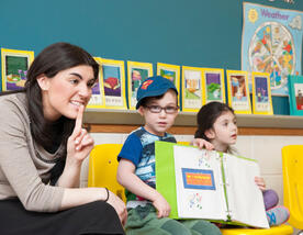 Teacher with a child holding a book